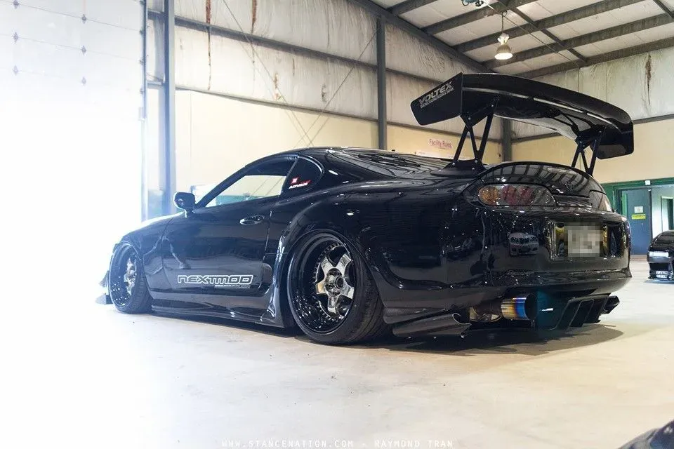 Toyota Supra MK4 with a GRAMS GT wing, side skirts and wide arches in the workshop