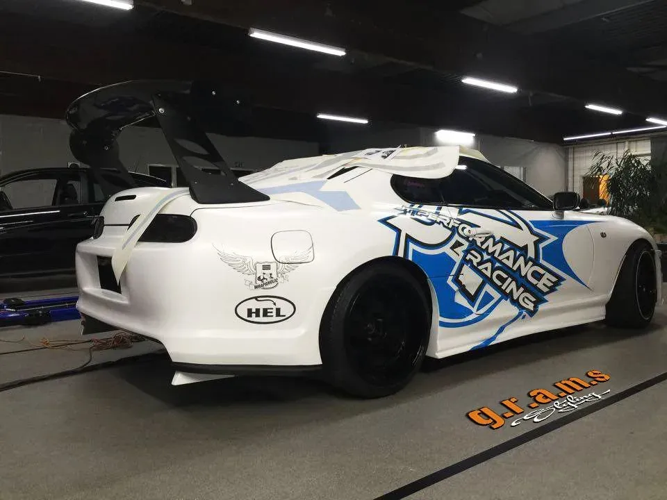 Toyota Supra race car with GRAMS wide arches, side skirts and GT wing